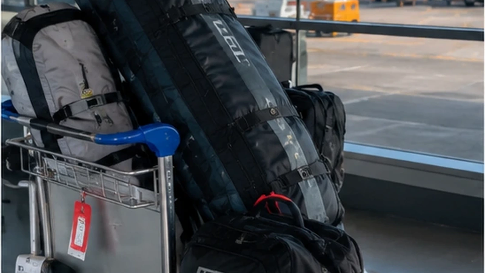 Kitesurf travel bag on an airport luggage trolley at check-in